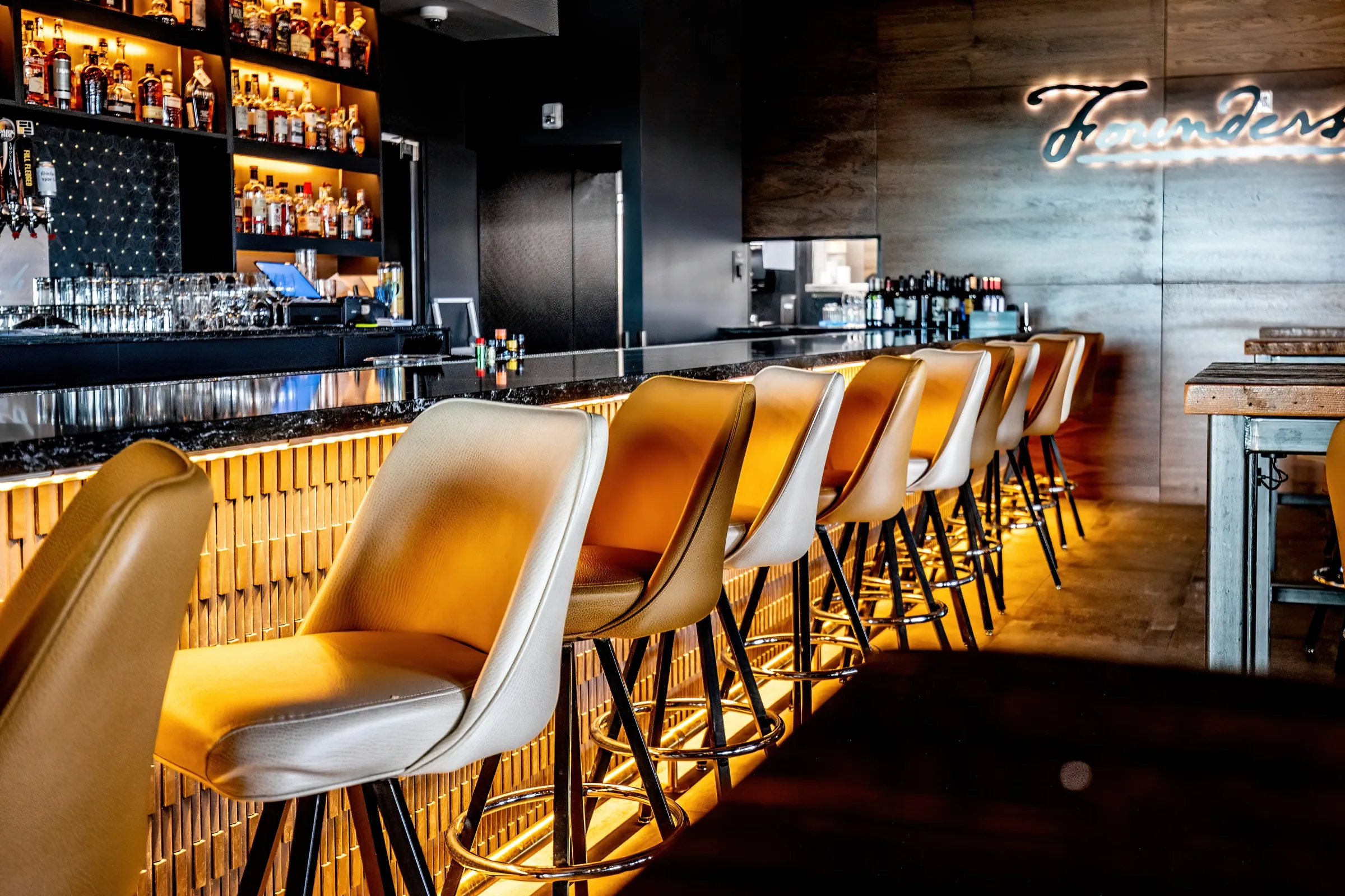 Red velvet banquette against a timber wall carrying the 88 Tactical crest