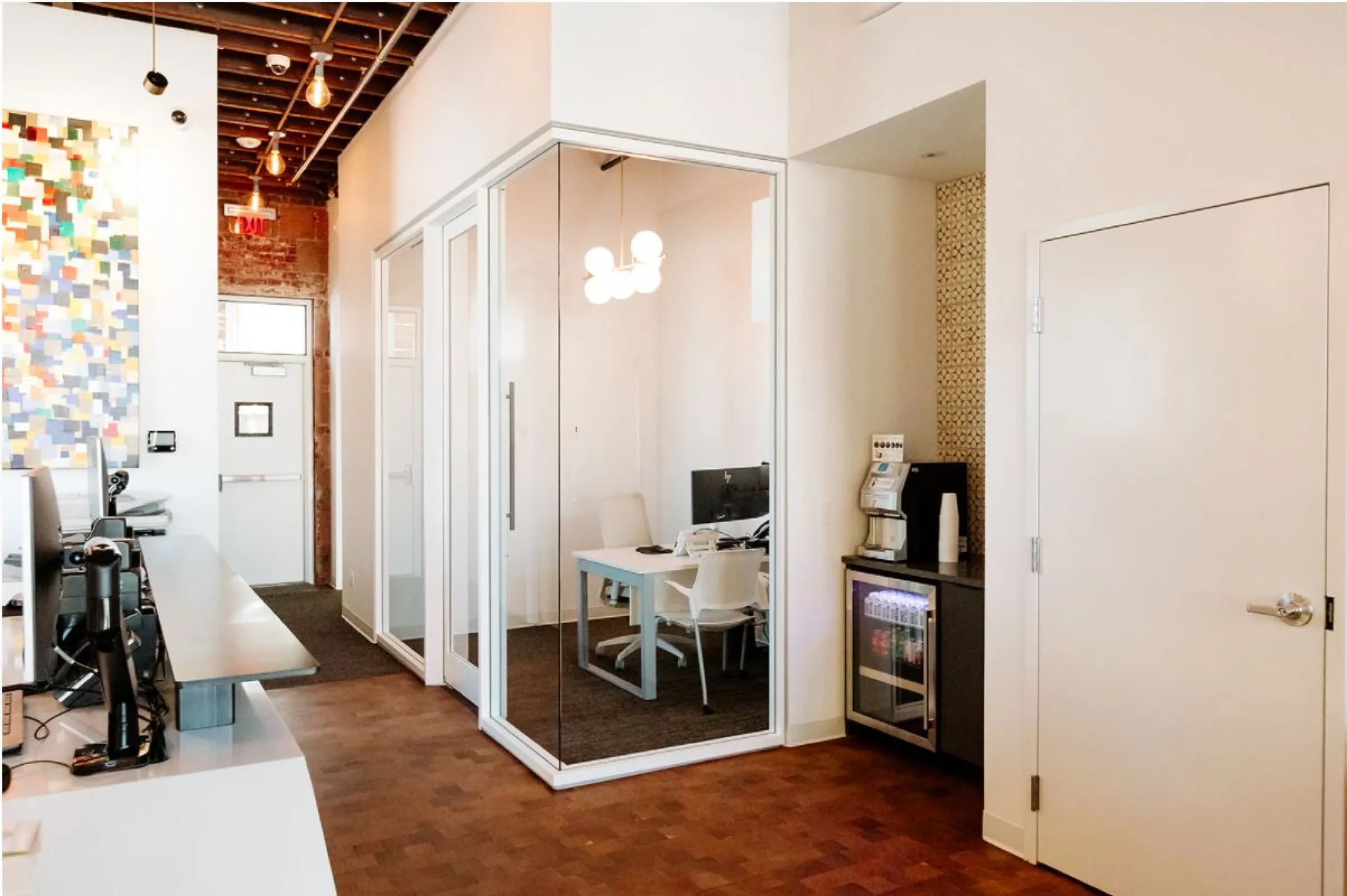 Open banking floor with exposed brick, timber ceiling and a steel stair