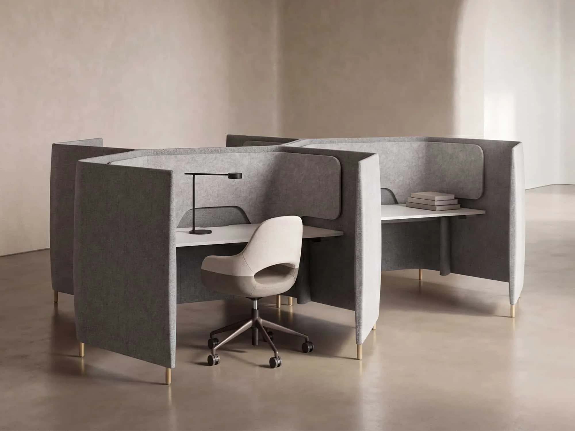 Upholstered privacy pods with task seating and integrated lighting